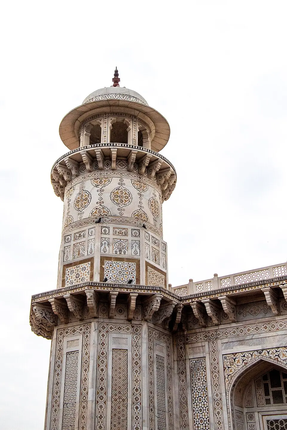 Pietra dura at Itmad ud Daula: A corner tower of the Baby Taj, its white marble inlaid with coloured stone, the first extensive Mughal use of pietra dura.