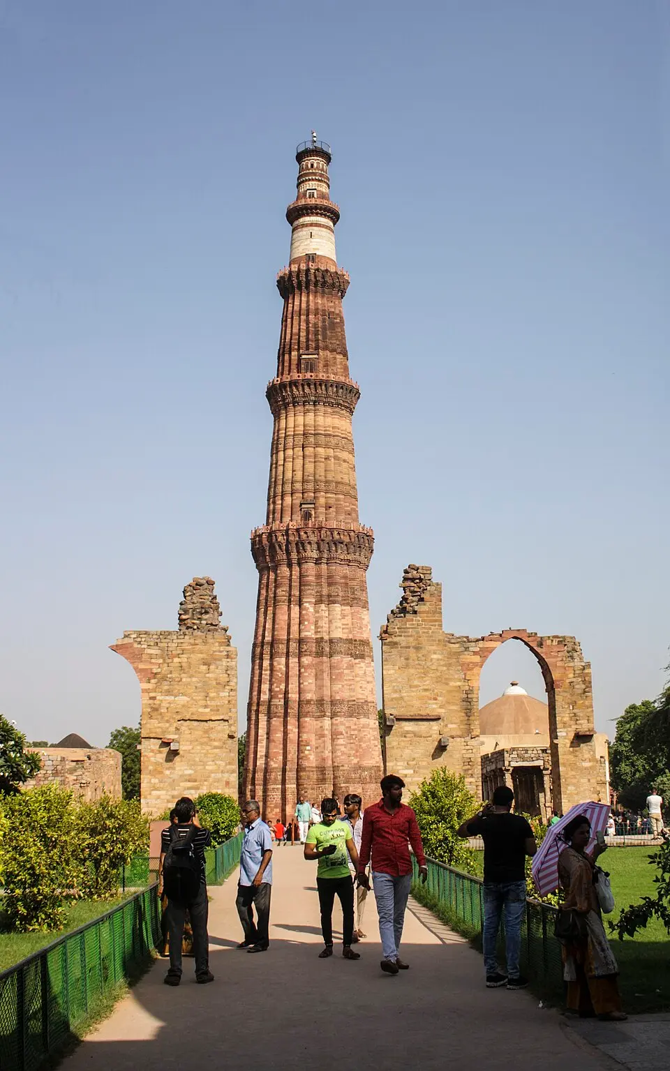 The Qutb complex: The Qutb Minar, 72.5 metres, begun by Aibak and completed by Iltutmish, among the ruins of the Quwwat ul Islam mosque.