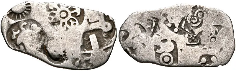 A punch marked coin of Magadha: Punch marked coins, early coins marked with symbols punched onto metal, show monetisation, trade and an exchange economy.
