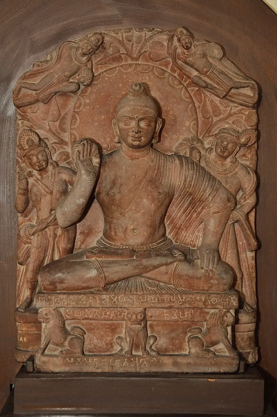 Seated Buddha from Katra, Mathura, in red sandstone with raised right hand