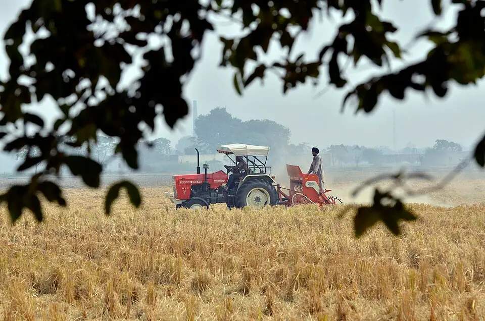 A tractor preparing a Punjab field for wheat without burning the previous crop's stalks