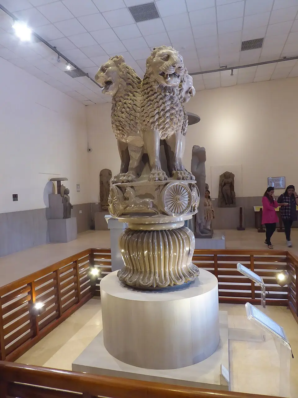 Lion capital of Ashoka from Sarnath with four lions on a drum carrying wheels and animals