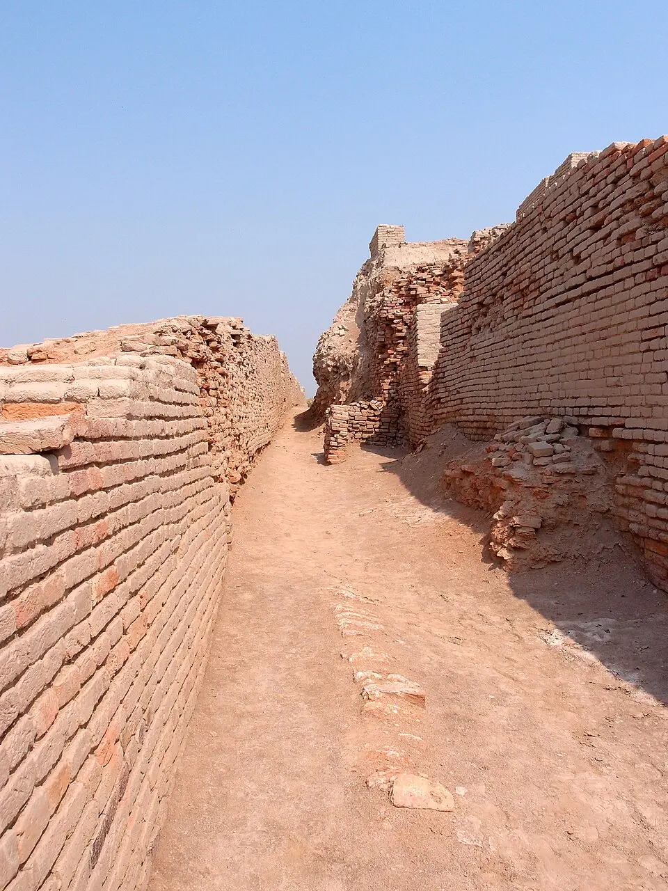 A street at Mohenjo daro with brick walls on both sides